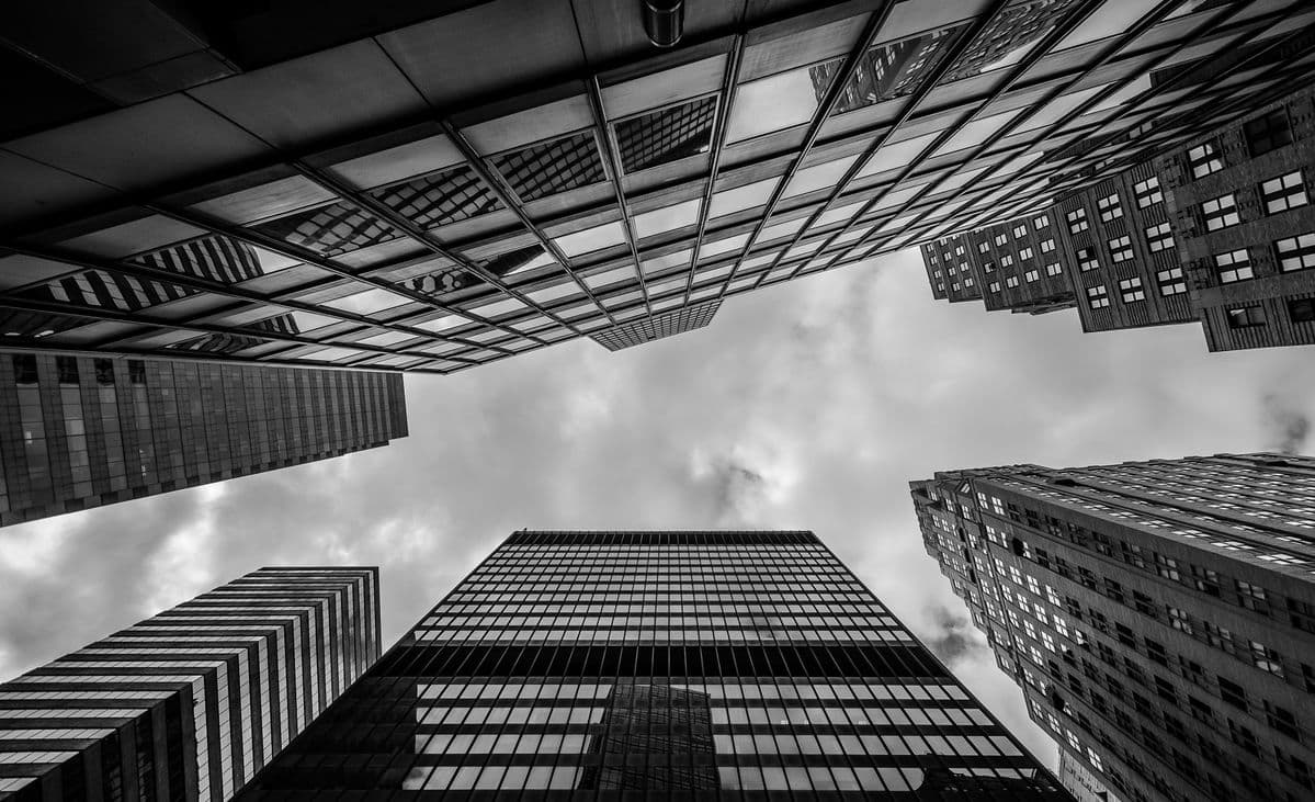 Skyscrapers seen from street level, looking up toward the sky